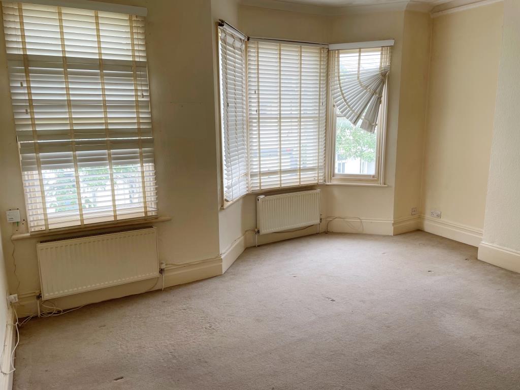 Lot: 23 - MIXED USE PART POSSESSION FOR INVESTMENT - front living room with bay window and blinds
